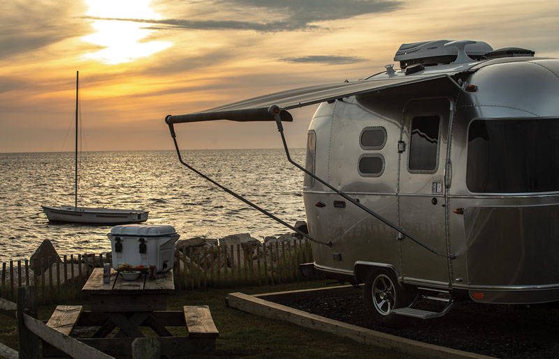 Airstream RV Caravel Travel Trailer in front of ocean view