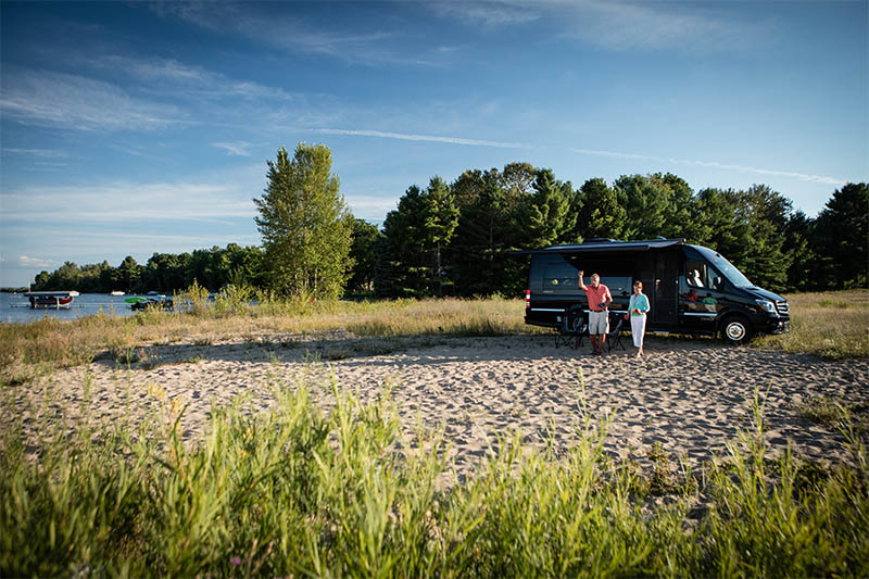 Couple with Interstate Grand Tour EXT Touring Coach