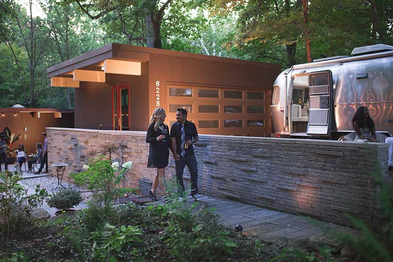 Couple next to Airstream International Signature Travel Trailer