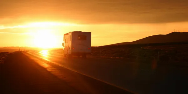 RV Driving Toward Sunset