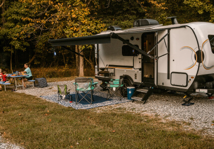 Travel trailer parked at a campsite.