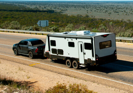 Truck towing an RV on the road