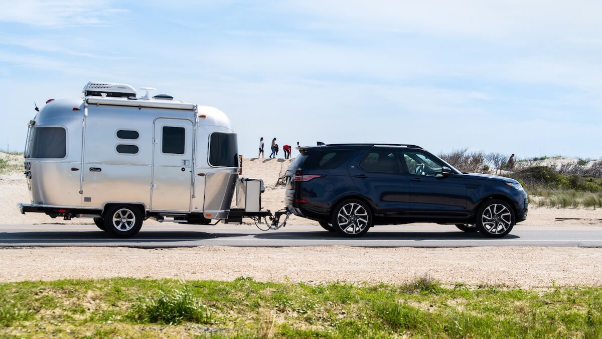 An Airstream trailer being towed by an SUV