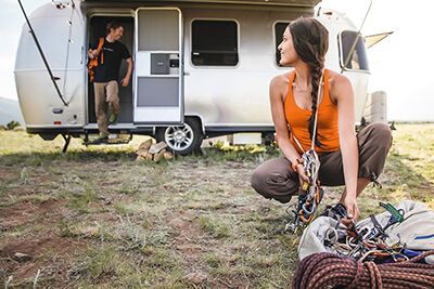 Couple outside of their Airstream RV