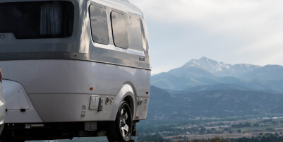 Airstream with a mountain backdrop.