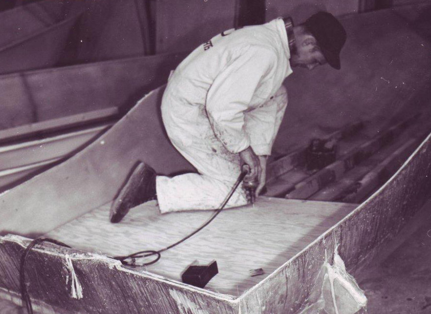Old picture of man working on boat