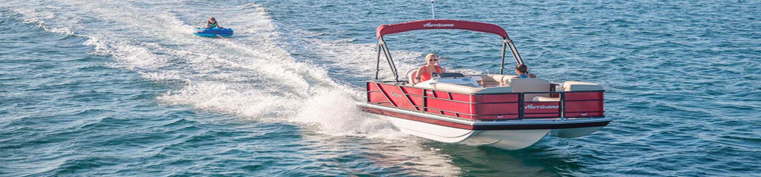 Pontoon Boat with person on tube behind