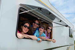 family smiling in an RV