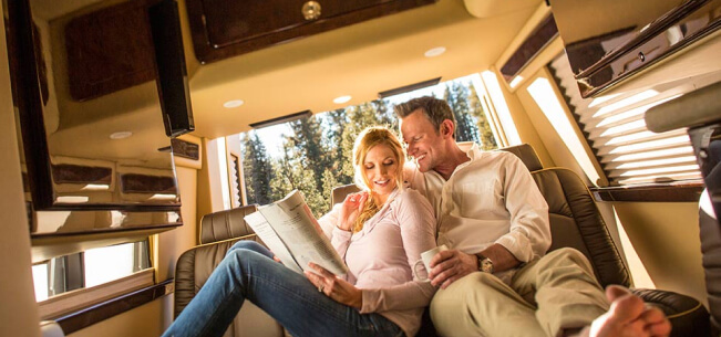 happy couple sitting together in their RV