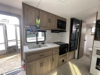 Interior kitchen with appliances in new 2025 Coachmen Freedom Express Ultra Lite 252RBS RV