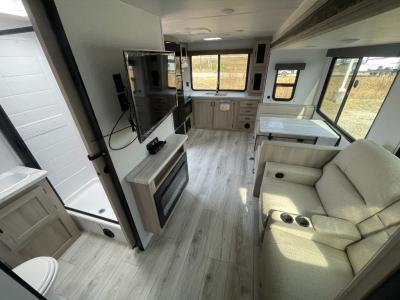 Living room with theater seating, booth dinette, entertainment center   in new 2025 East to West Della Terra 263RK RV