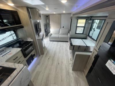 Spacious living area with kitchen, dinette, theater seating/trifold sofa option of new 2025 East to West Alta 3010KBH RV