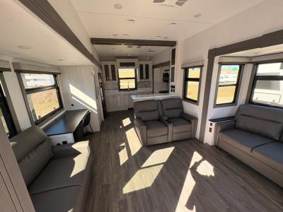 Very spacious living area with 2 slides containing trifold sofas, one with a desk, in new 2026 East to West Ahara 395FB