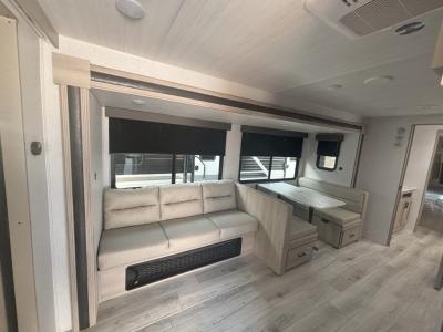 Living room has a generous slide with jack knife sofa and booth dinette in new 2025 east to West Della Terra 312BH RV