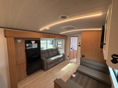 Spacious living area with slide: theater seating, pantry, refrigerator; dinette, in new 2026 Keystone Passport Super Lite 2450RK