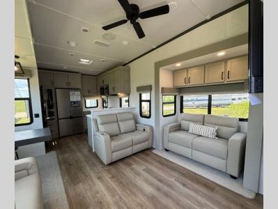 Very spacious living area with opposing pullout sofas and theater seating in new 2025 Palomino Columbus 384RKH fifth wheel