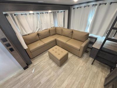 Sofas in spacious living area of new 2026 Forest River Impression 44STAY RV
