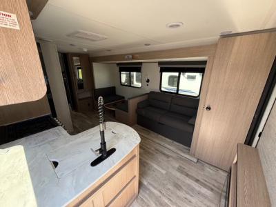 Spacious interior with living room slide and full kitchen with appliances in new 2026 Gulf Stream Ameri-Life Ultra Lite 274QB RV