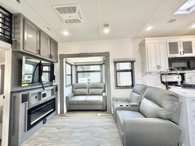 Spacious living area with fold-down sofa and theater seats in new 2026 East to West Ahara 385DS