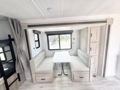 Attractive booth dinette with storage in cozy slide in new 2026 east to West Della Terra 241BH RV