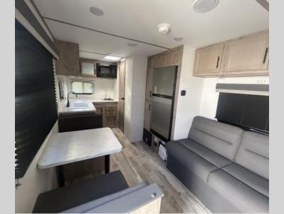 Squared away living quarters of new 2026 Gulf Stream Ameri-Lite Super Lite 199RK RV with sofa and convertible booth dinette