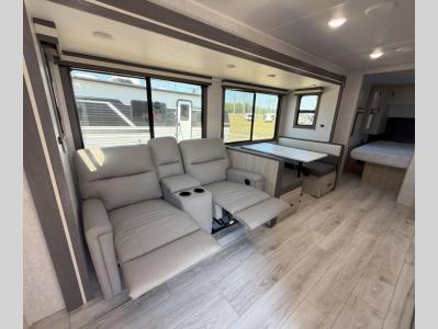 Living room slide with theater seats and booth dinette in new 2026 East to West Della Terra 261RB travel trailer