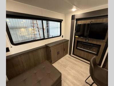 Stylish living area with chaise lounge in front of entertainment center and fireplace