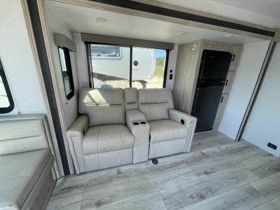 Reclining theater seats in cozy slide extension with refrigerator in new 2025 East to West Della Terra 251RD RV
