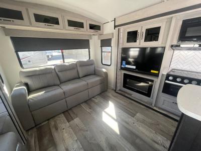 2025 CrossRoads Sunset Trail SS330SI travel trailer rear living room with tri-fold sofa