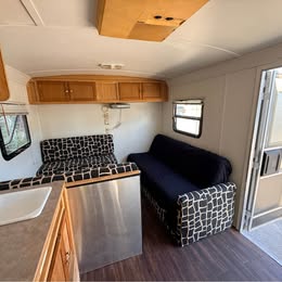 Sleeper sofa and dinette at the front of the converted trailer used 2003 RMST CT toy hauler
