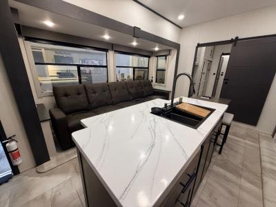 Five piece sectional recliner in slide in living area; kitchen center island in new 2026 Prime Time Sanibel 39HYBRID