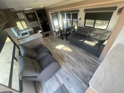 Spacious living area with theater seats, sleeper sofa and generous kitchen in new 2025 Gulf Stream Conquest Supreme 302SBW RV