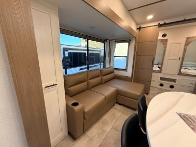 Chaise lounge and pantry in living area slide opposite game/dining table in new 2026 Forest River RV Impression 36BR3