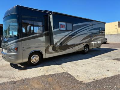Driver's side view with living room slide out with slide top awning