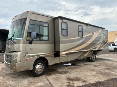 Driver's side view with kitchen slide out that has awning cover