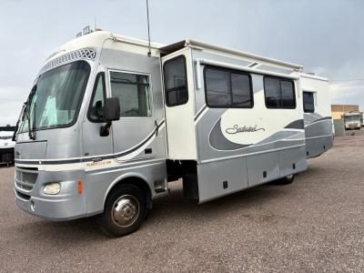 Driver's side view with living room slide out with covered awning