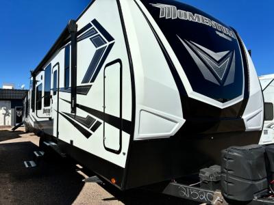 Front cap, driver's side view with 19' power awning and outdoor speakers
