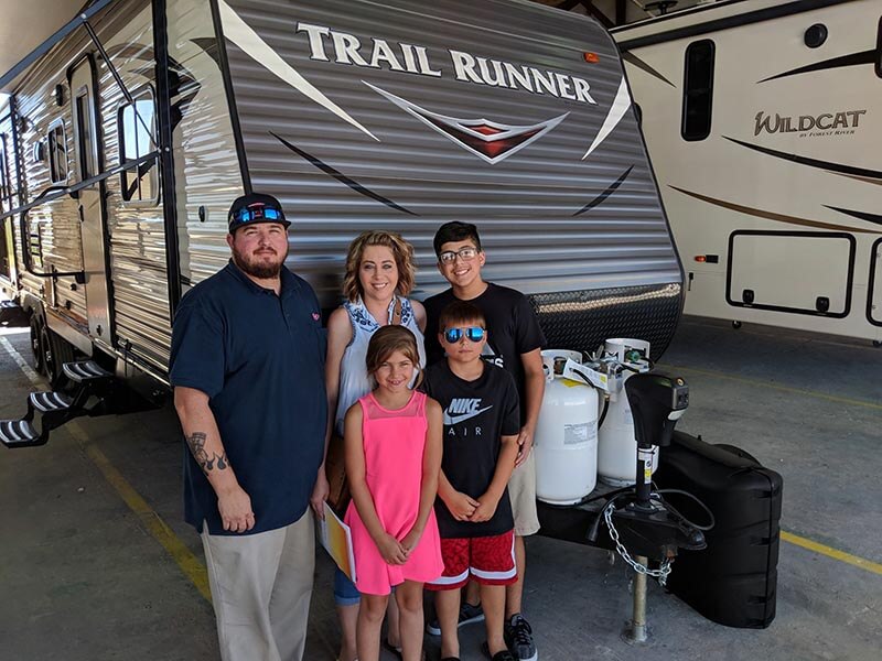 Family in front of their new RV