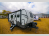 Side profile with entry steps, awning, and slide-out extended.