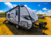 Front three-quarter angle of the 2025 Jayco Jay Feather 23RK travel trailer with a curved fiberglass front cap.