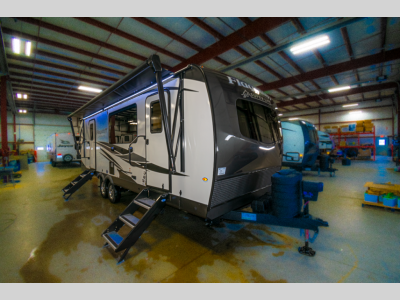 Front exterior view of the 2025 Forest River RV Flagstaff Super Lite 26SFK, showcasing its sleek design and dual propane tanks.