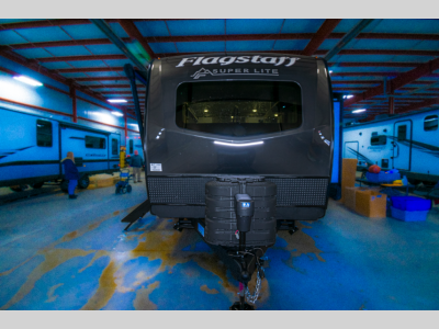 Close-up of the aerodynamic front cap with hitch and logo for the Flagstaff Super Lite RV.