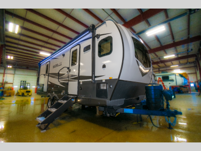 Side profile of the RV showcasing tinted windows and aerodynamic build