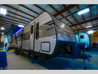 side view showing full body length, large awning, and outdoor speakers.