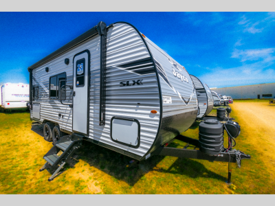 Front angle view of the 2025 Jayco Jay Flight SLX 211MB travel trailer parked on grass.