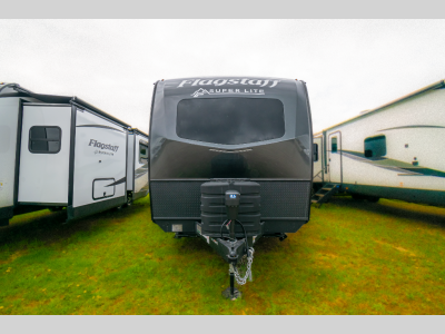 Head-on view of the trailer with front cap, electric tongue jack, and propane tanks.