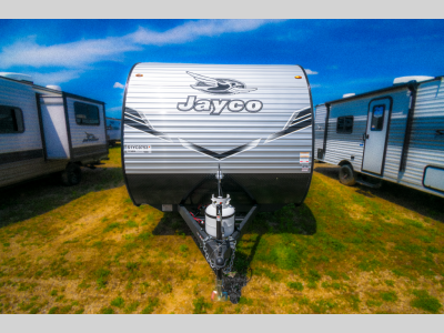 Straight-on front shot of the travel trailer with propane tank and hitch assembly visible.