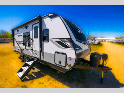 Side view showcasing the dual-axle setup and main entrance door with fold-down steps.
