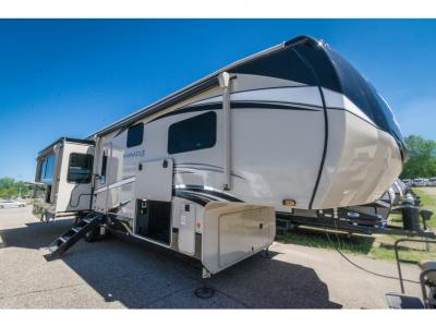Front angled exterior view of the 2022 Jayco Pinnacle 36KPTS luxury fifth wheel with hitch and aerodynamic design