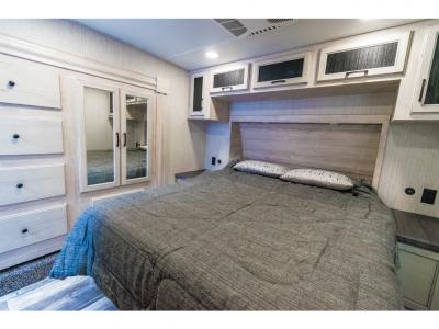 Master Bedroom: Spacious master bedroom with queen bed, overhead storage, and stylish interior finishes